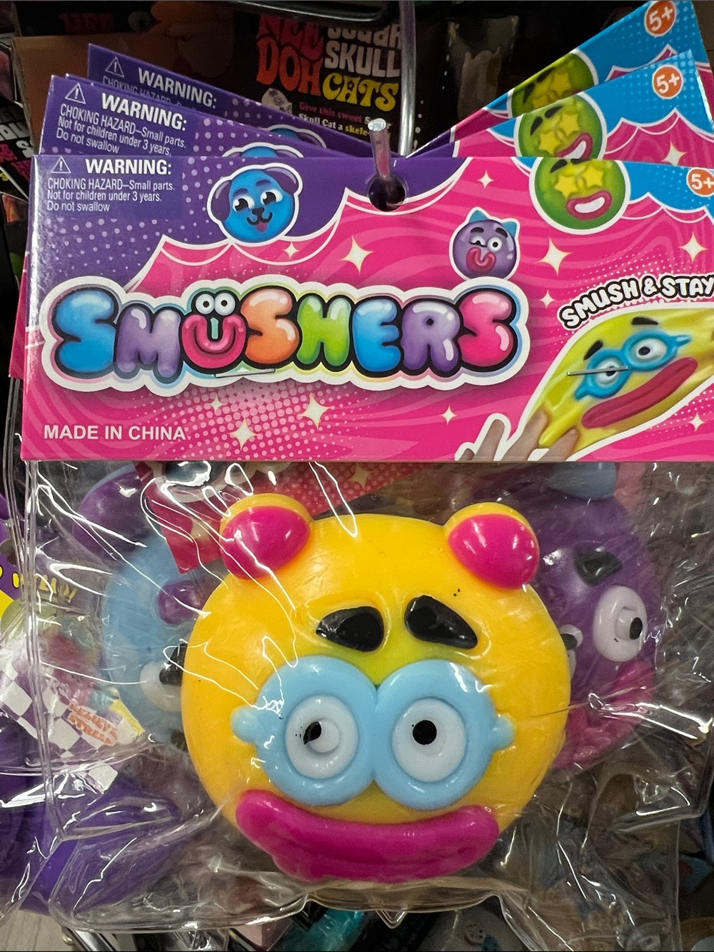 Smushers Yellow Monster Squishy Toy with Blue Goggles and Pink Accents